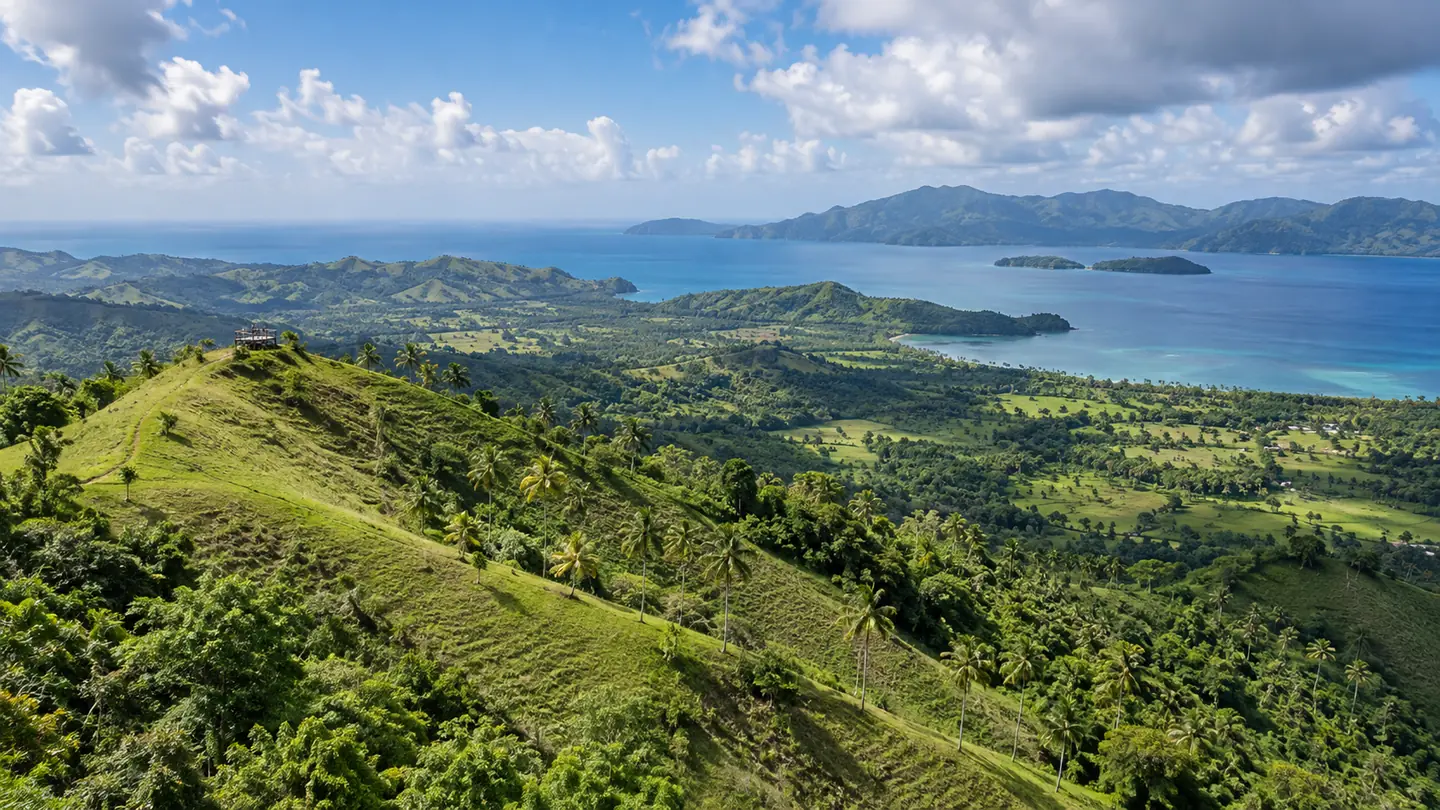 Blue water and green coastline seen from a mountain viewpoint in the Dominican Republic